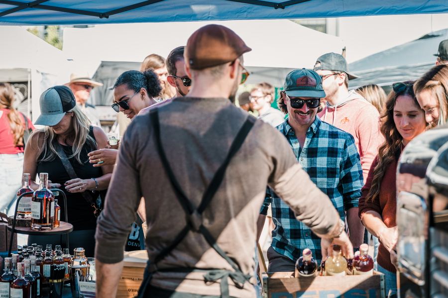 A crowd gathers at a Colorado distiller's tasting booth