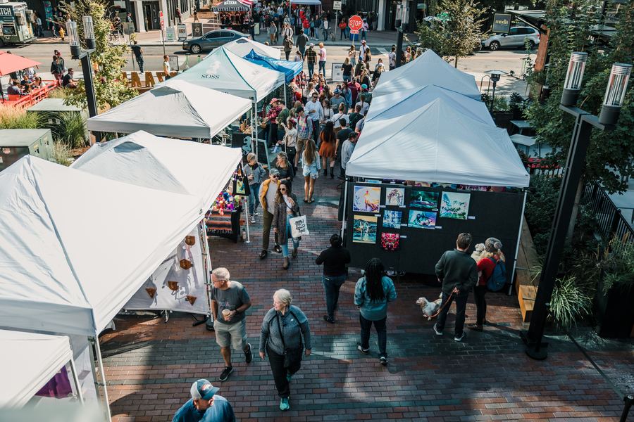 Overhead view of maker tents and shoppers on brick pavers
